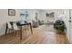 Open-concept living space with stylish furniture, a dining area, and hardwood floors at 6068 Lee St, Arvada, CO 80004