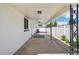 Comfortable covered patio with concrete flooring, white walls, and wrought iron supports at 6068 Lee St, Arvada, CO 80004