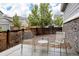 Cozy outdoor patio with metal chairs, small round table, and privacy fence at 640 E Fremont Pl, Littleton, CO 80122