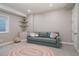 Finished basement seating area with plush couch, colorful rug, corner shelves, and window for natural light at 640 E Fremont Pl, Littleton, CO 80122