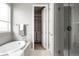 Modern bathroom features tub, walk-in shower and open walk-in closet space at 640 E Fremont Pl, Littleton, CO 80122