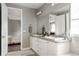 Bathroom boasts double sinks, granite countertops, and white cabinetry at 640 E Fremont Pl, Littleton, CO 80122