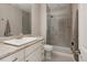 Modern bathroom with a sleek glass-enclosed shower, granite vanity, and contemporary fixtures at 640 E Fremont Pl, Littleton, CO 80122