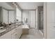 Well-lit bathroom featuring double vanity, granite countertops, separate tub, and shower at 640 E Fremont Pl, Littleton, CO 80122