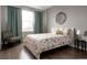 Charming bedroom with floral bedding and accent chair with plenty of natural light at 640 E Fremont Pl, Littleton, CO 80122