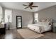 Spacious primary bedroom with hardwood floors, natural light, and ceiling fan at 640 E Fremont Pl, Littleton, CO 80122