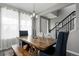 Open dining area featuring a wooden table with large windows and a staircase at 640 E Fremont Pl, Littleton, CO 80122