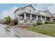 Charming two-story home with a welcoming front porch, stone accents, and lush landscaping at 640 E Fremont Pl, Littleton, CO 80122