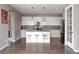 Spacious kitchen with granite countertops, stainless steel appliances, modern lighting, and an island with seating at 640 E Fremont Pl, Littleton, CO 80122