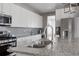 Close up view of the beautiful kitchen featuring granite countertops, stainless appliances, and a grey backsplash at 640 E Fremont Pl, Littleton, CO 80122