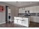 Modern kitchen featuring granite countertops, stainless steel appliances, lighting, and an island with seating at 640 E Fremont Pl, Littleton, CO 80122