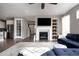 Open-concept living room with a fireplace, hardwood floors, and views into the kitchen at 640 E Fremont Pl, Littleton, CO 80122