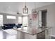 Open-concept kitchen and living room with granite countertops, stainless appliances, and comfortable seating at 640 E Fremont Pl, Littleton, CO 80122