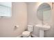 Bathroom featuring a toilet and pedestal sink at 16203 E 47Th Pl, Denver, CO 80239