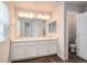 Bathroom view with double sinks and white cabinetry at 16203 E 47Th Pl, Denver, CO 80239