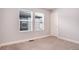 Bright bedroom with large windows and neutral carpeting at 16203 E 47Th Pl, Denver, CO 80239