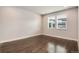 A bright, empty bedroom with hardwood floors and large windows offering ample natural light at 16203 E 47Th Pl, Denver, CO 80239