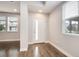 Bright entryway features wood-look flooring, white door with glass, and natural light at 16203 E 47Th Pl, Denver, CO 80239
