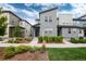 Modern townhouse showcasing gray facade, landscaped front yard and inviting walkway at 16203 E 47Th Pl, Denver, CO 80239