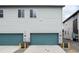 Attached two-car garage with modern doors and ample parking space at 16203 E 47Th Pl, Denver, CO 80239