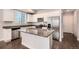 Modern kitchen with stainless steel appliances, granite counters, and sleek white cabinetry at 16203 E 47Th Pl, Denver, CO 80239