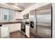 Kitchen showcasing stainless steel appliances, granite counters and white cabinets at 16203 E 47Th Pl, Denver, CO 80239