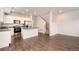 Open-concept kitchen with stainless steel appliances, granite counters, and modern white cabinets at 16203 E 47Th Pl, Denver, CO 80239