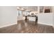 Open-concept design with kitchen view, hardwood floors, and natural light from large windows at 16203 E 47Th Pl, Denver, CO 80239