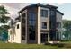 Modern home with stone and wood siding, showcasing large windows and a balcony at 401 Madison St, Denver, CO 80206