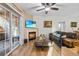 Cozy living room features a fireplace and sliding glass doors leading to a patio at 8422 S Upham Way # H61, Littleton, CO 80128