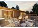 Back deck with fire pit and cozy seating area overlooking the backyard at 7841 Deertrail Dr, Parker, CO 80138