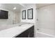 Bathroom with white counter, wood cabinets, tub and shower with white tile at 7841 Deertrail Dr, Parker, CO 80138