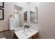 Updated bathroom with white marble counter, modern fixtures and decorative mirror cabinet at 7841 Deertrail Dr, Parker, CO 80138
