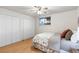 Bedroom with bright window view features neutral walls, hardwood flooring and a double door closet at 7841 Deertrail Dr, Parker, CO 80138