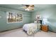 Cozy bedroom with ample sunlight, carpet and ceiling fan features peaceful scenic views at 7841 Deertrail Dr, Parker, CO 80138