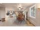 Open dining area connecting to a living room and kitchen, featuring a round table and multiple windows at 7841 Deertrail Dr, Parker, CO 80138