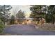 Charming home with a spacious driveway, surrounded by mature trees and lush greenery at 7841 Deertrail Dr, Parker, CO 80138