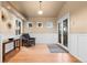 Inviting entryway with hardwood floors, wainscoting, and natural light at 7841 Deertrail Dr, Parker, CO 80138