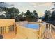 Relaxing hot tub nestled on a wooden deck with views of the surrounding trees at 7841 Deertrail Dr, Parker, CO 80138