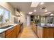 Open kitchen with a kitchen island, stainless steel appliances, and natural wood cabinets at 7841 Deertrail Dr, Parker, CO 80138