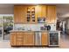 Well-lit kitchen with wooden cabinets and stainless steel appliances, including a beverage fridge at 7841 Deertrail Dr, Parker, CO 80138