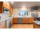 Bright kitchen features stainless steel appliances, quartz countertops, and wood cabinets at 7841 Deertrail Dr, Parker, CO 80138