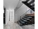 Hallway and staircase with carpeted steps and tile flooring lead to other parts of the home at 7841 Deertrail Dr, Parker, CO 80138
