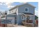 Charming two-story home with light blue siding, white trim, and a cozy front porch at 760 W Asbury Ave, Denver, CO 80223