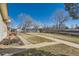 Backyard view of pond with walkway, blue sky and few trees at 57 Scott S, Broomfield, CO 80020