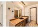 Bathroom with double vanity sinks, carpeted floors, and plenty of lighting at 57 Scott S, Broomfield, CO 80020