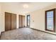 Bedroom featuring plush carpet, lots of natural light, and spacious closets at 57 Scott S Dr, Broomfield, CO 80020