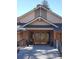 Inviting entrance featuring a covered walkway and double doors, creating a warm and welcoming first impression at 57 Scott S Dr, Broomfield, CO 80020