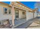 Rear view of a well-kept home featuring a covered patio area with bright white fencing and ample natural light at 57 Scott S, Broomfield, CO 80020