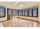 Bright sunroom featuring large windows with decorative valances, tile flooring, skylight, and ample natural light at 57 Scott S, Broomfield, CO 80020